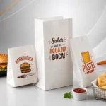 Três sacos de papel branco com barreira antigordura para hambúrgueres, pastéis e delivery, modelos sanfonado e fundo quadrado (SOS), ideais para food service e lanchonetes.