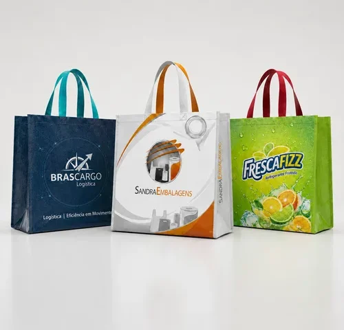 Três sacolas de ráfia laminada personalizadas com impressão de alta qualidade para empresas, alinhadas em estúdio sobre fundo branco, representando embalagens promocionais reutilizáveis para ações de marketing e eventos corporativos.